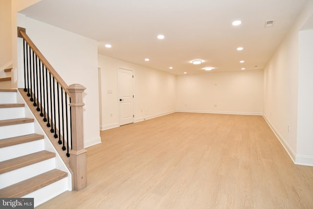 basement with recessed lighting, visible vents, baseboards, light wood-style floors, and stairway