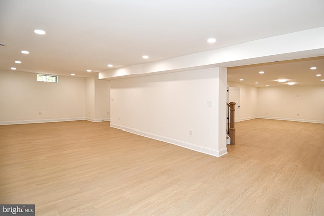 below grade area featuring recessed lighting, light wood-style flooring, and baseboards