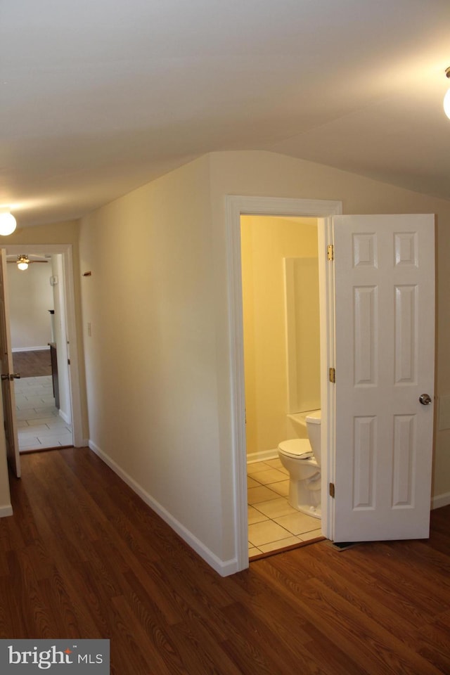 hall featuring baseboards and wood finished floors