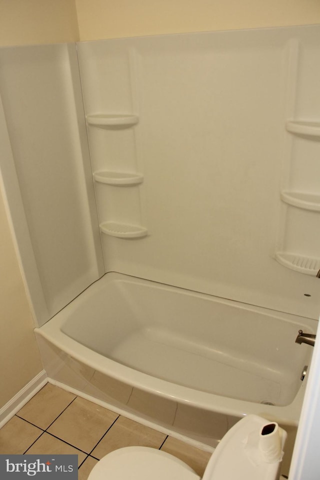 full bathroom featuring toilet, baseboards,  shower combination, and tile patterned floors