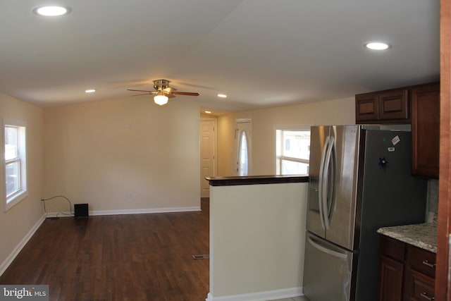 kitchen featuring dark wood-type flooring, stainless steel refrigerator with ice dispenser, and recessed lighting