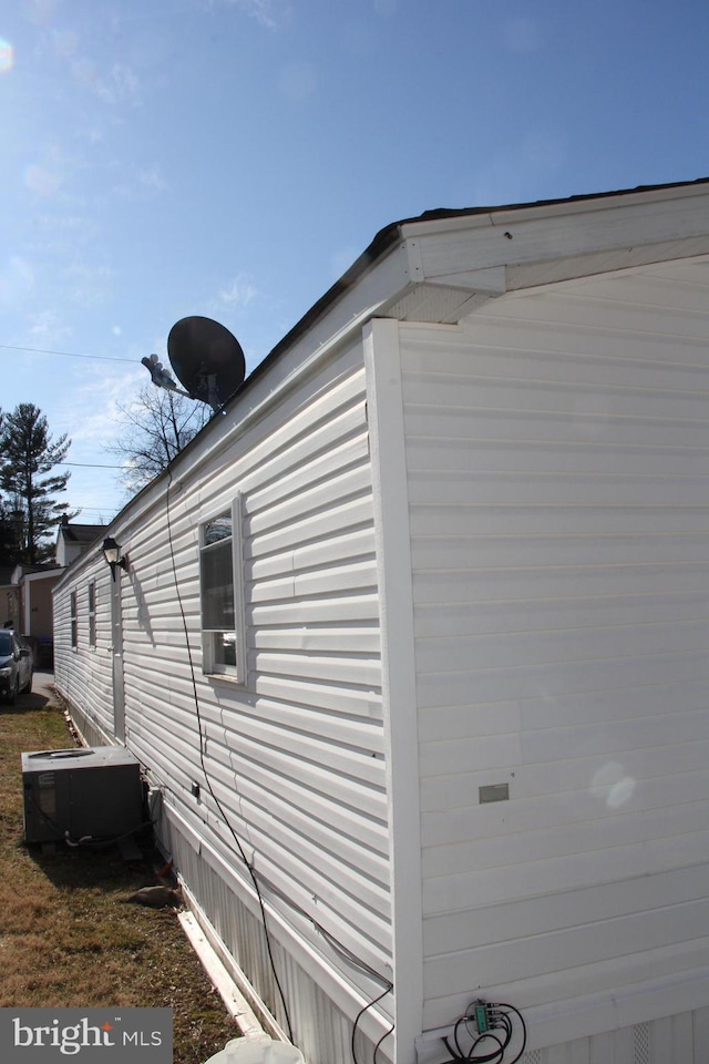 view of side of home featuring central AC unit