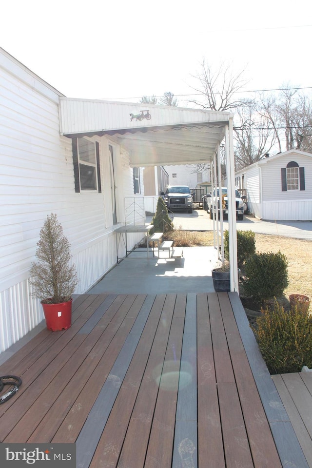 wooden deck with a carport