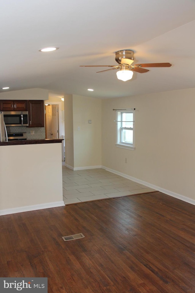 interior space with baseboards, visible vents, a ceiling fan, light wood-style floors, and recessed lighting