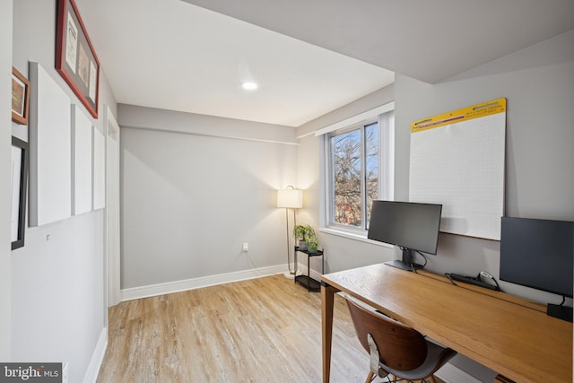 office space with baseboards and wood finished floors