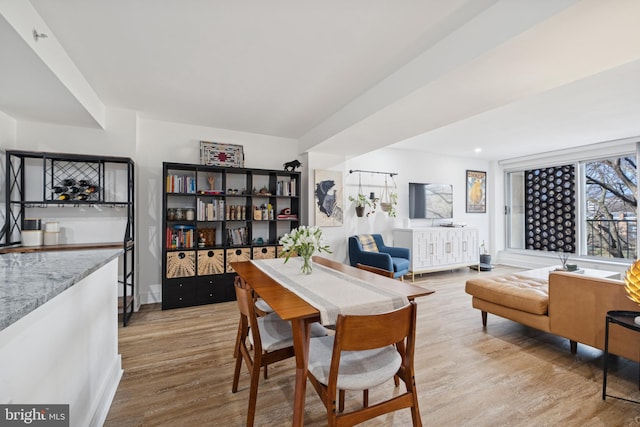 dining room featuring baseboards and wood finished floors