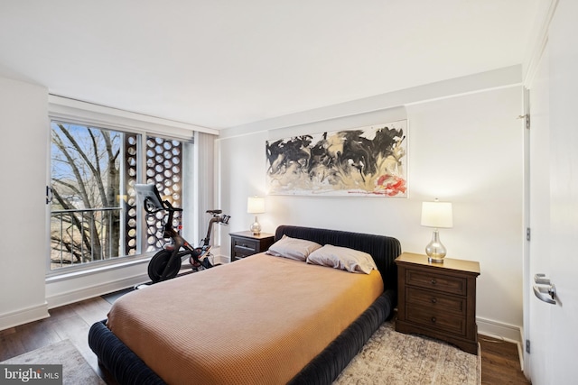 bedroom with wood finished floors and baseboards