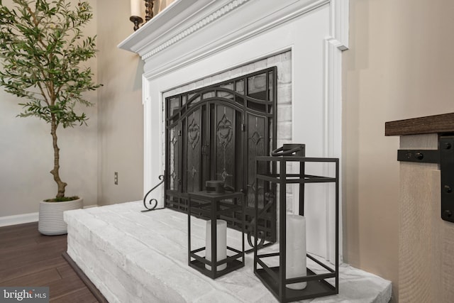 room details featuring baseboards and wood finished floors