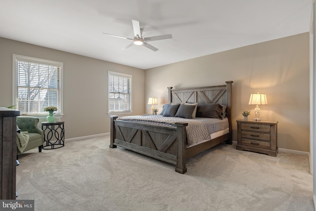 carpeted bedroom featuring baseboards and a ceiling fan