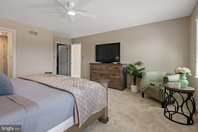 bedroom with visible vents, light carpet, and ceiling fan