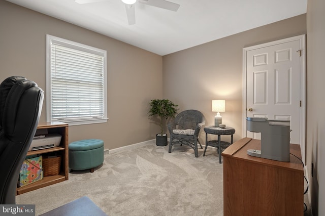 office space with baseboards, ceiling fan, and carpet floors