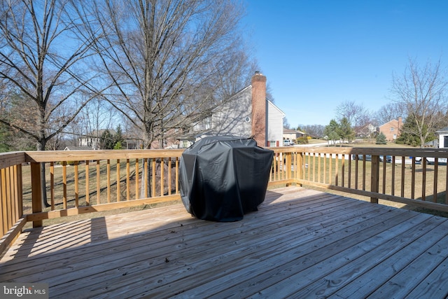 wooden deck with a grill