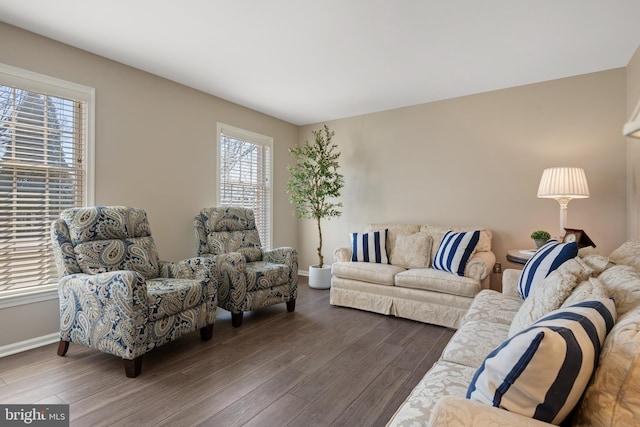 living area featuring dark wood-style floors and baseboards