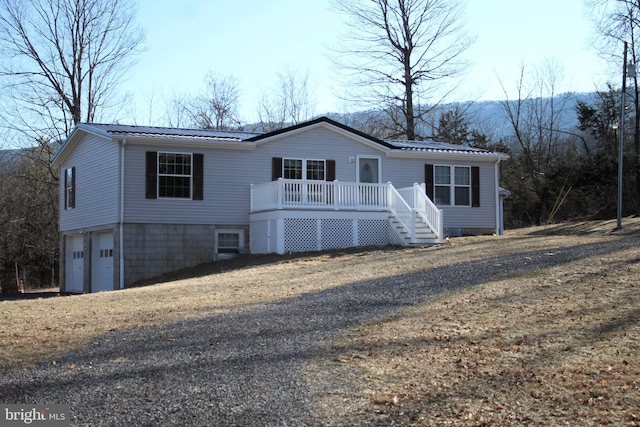 view of front of property featuring metal roof and an attached garage