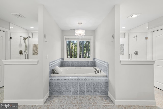 bathroom featuring a bath, baseboards, and a shower stall