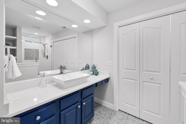 bathroom featuring tile patterned flooring, vanity, recessed lighting, baseboards, and a stall shower