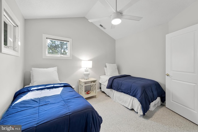 bedroom with vaulted ceiling, a ceiling fan, a textured ceiling, visible vents, and carpet