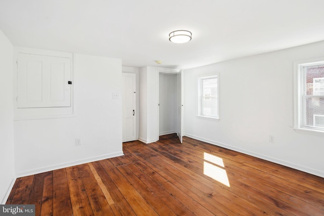 spare room with plenty of natural light, hardwood / wood-style floors, and baseboards