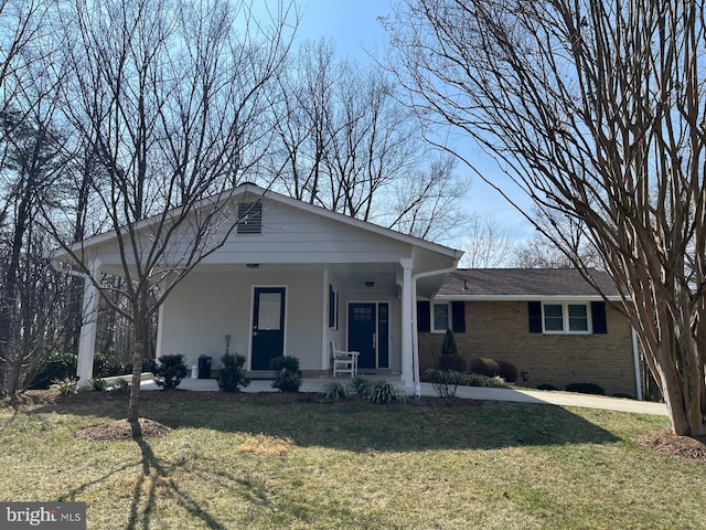 view of front facade featuring a front lawn, a porch, and brick siding