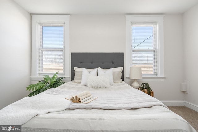 carpeted bedroom featuring baseboards