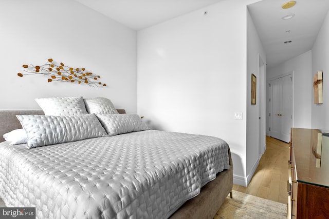 bedroom with baseboards and light wood-style floors