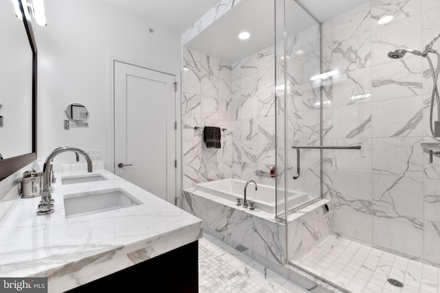 bathroom with a marble finish shower, a sink, a tub with marble appearance, and double vanity