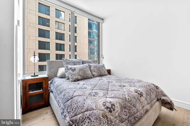 bedroom with wood finished floors and baseboards