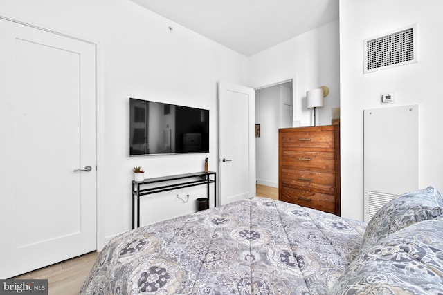 bedroom featuring visible vents and wood finished floors