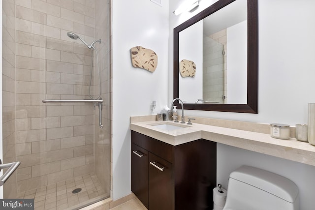 full bathroom featuring a stall shower, vanity, and toilet