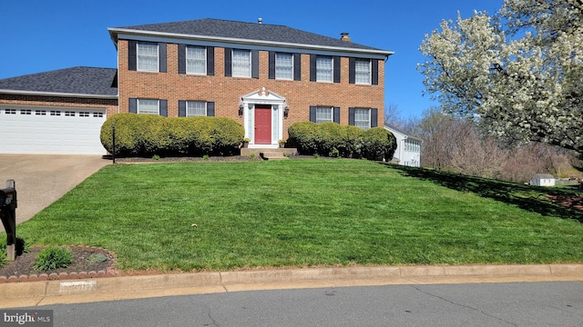 view of front facade with a garage, a shingled roof, concrete driveway, a front yard, and brick siding