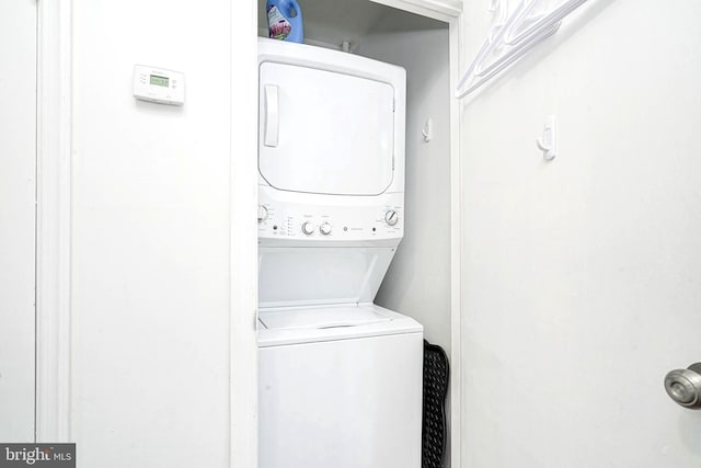 washroom featuring stacked washer / dryer