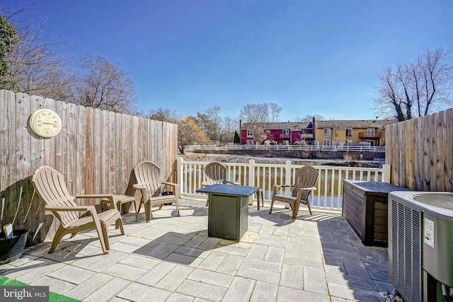 view of patio / terrace with fence and central AC unit