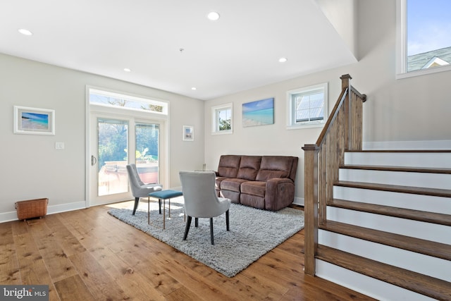 living area featuring stairway, recessed lighting, baseboards, and hardwood / wood-style floors