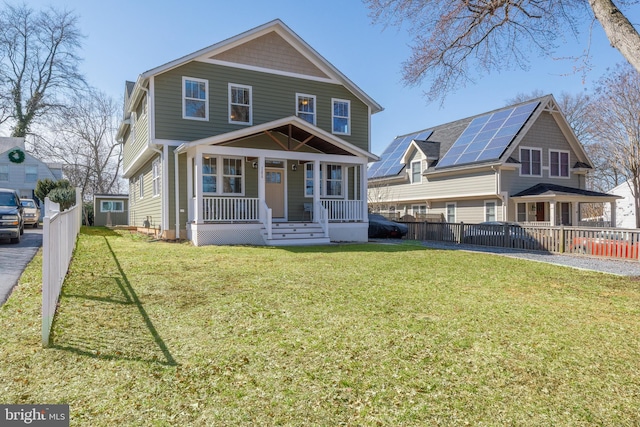 view of front facade with a porch, fence, and a front yard