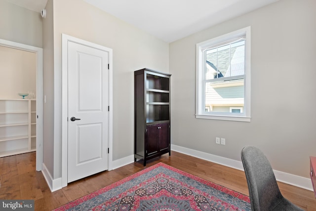 home office featuring baseboards and wood finished floors