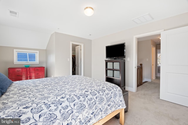 bedroom with visible vents, light carpet, baseboards, and vaulted ceiling