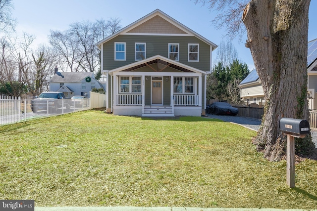 view of front of home with a front yard and fence