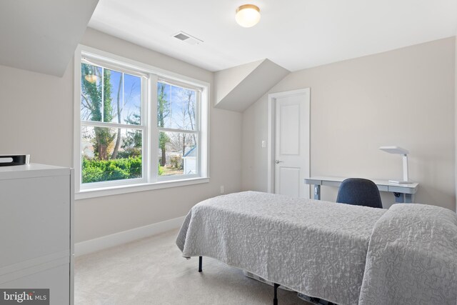 bedroom featuring washer / clothes dryer, baseboards, visible vents, and light carpet