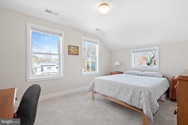 bedroom with visible vents, carpet flooring, baseboards, and lofted ceiling