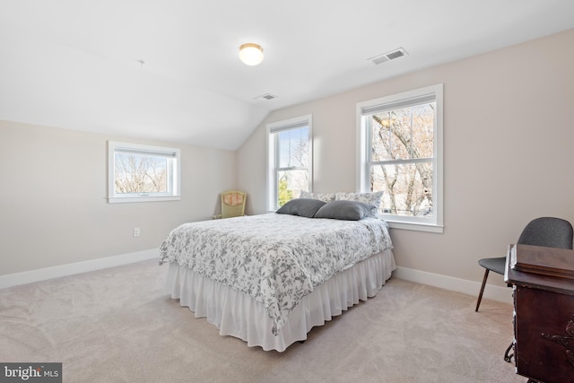 bedroom with visible vents, light colored carpet, and baseboards