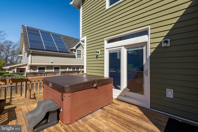 wooden deck with a hot tub