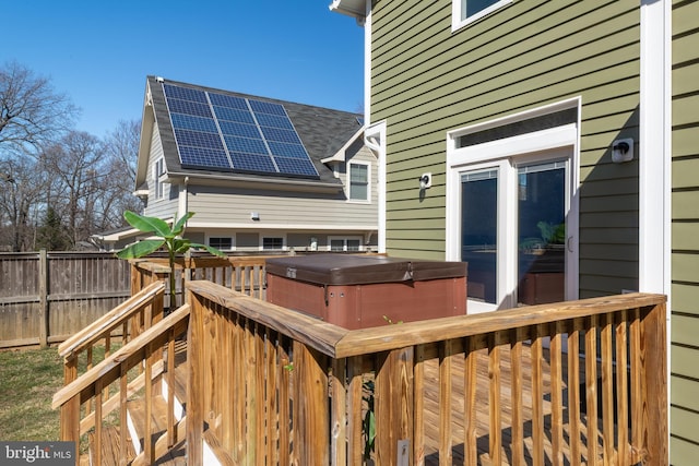 deck with fence and a hot tub