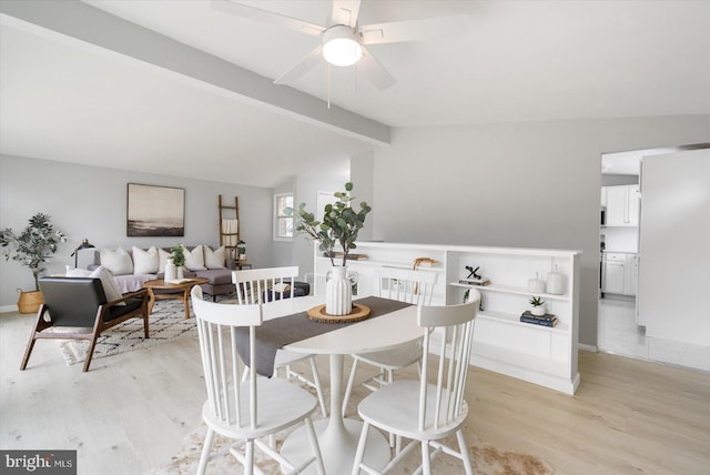 dining room with vaulted ceiling with beams, light wood finished floors, a ceiling fan, and baseboards