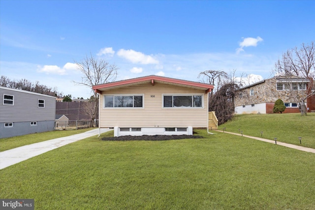 view of front facade with a front yard and concrete driveway