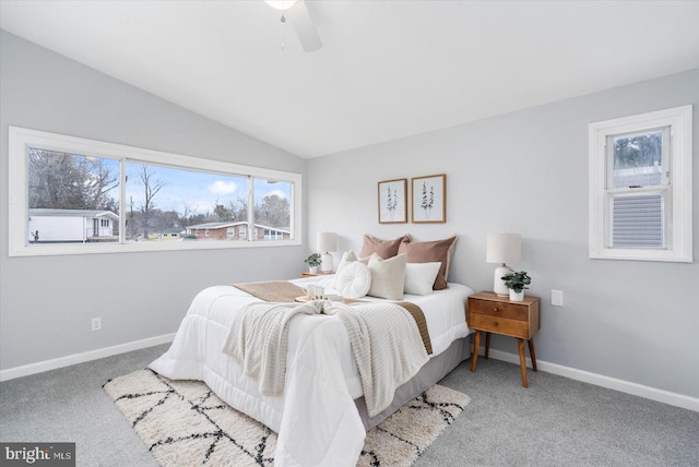 bedroom with lofted ceiling, ceiling fan, baseboards, and carpet flooring