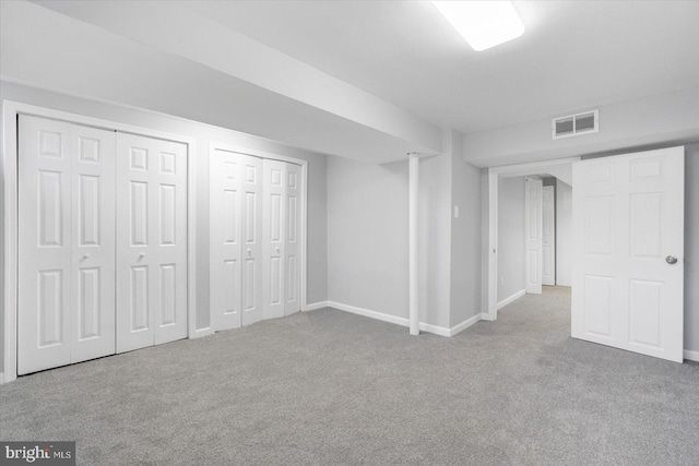 finished below grade area featuring carpet floors, visible vents, and baseboards