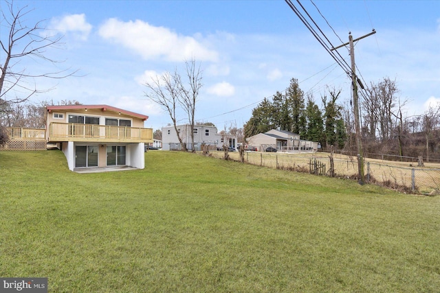 view of yard with a deck and fence