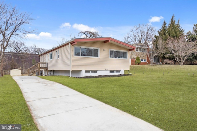 view of home's exterior with concrete driveway, a lawn, an outdoor structure, and a shed