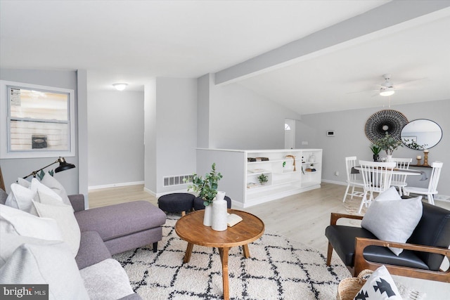 living room featuring vaulted ceiling with beams, visible vents, a ceiling fan, wood finished floors, and baseboards