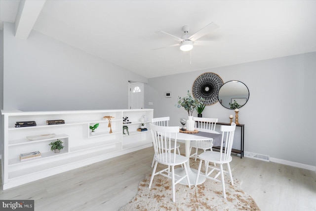 dining space with ceiling fan, baseboards, wood finished floors, and lofted ceiling